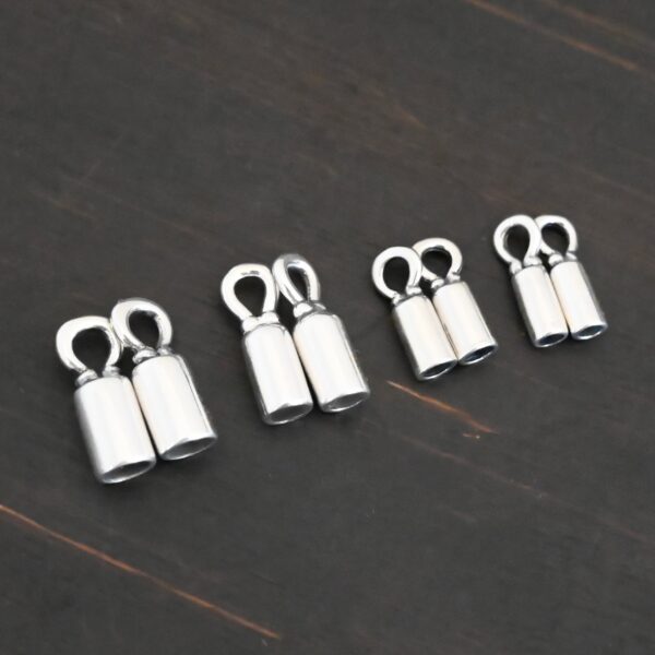 Silver shiny end caps shown on dark background