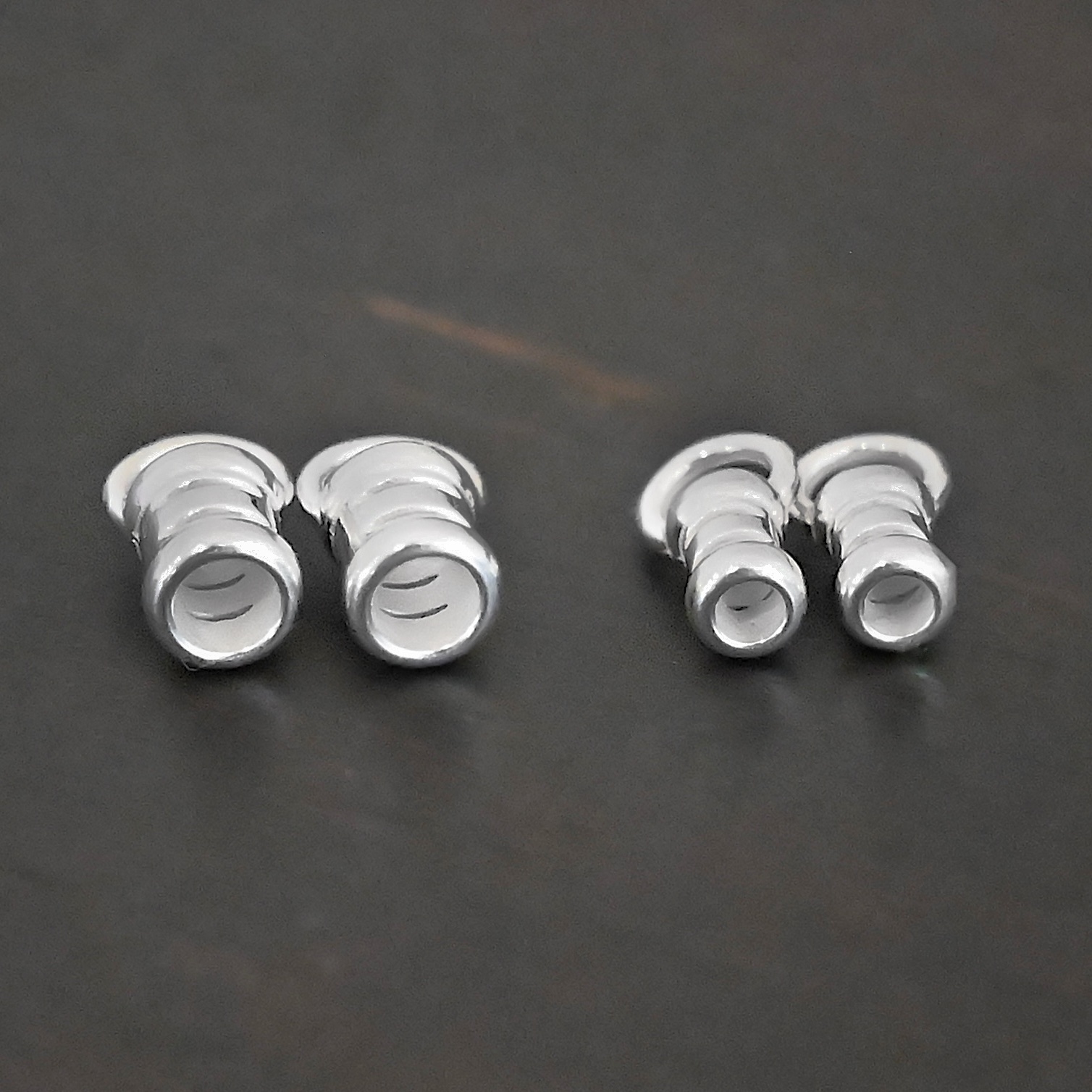 Silver shiny 2mm & 3mm crimps shown on dark background