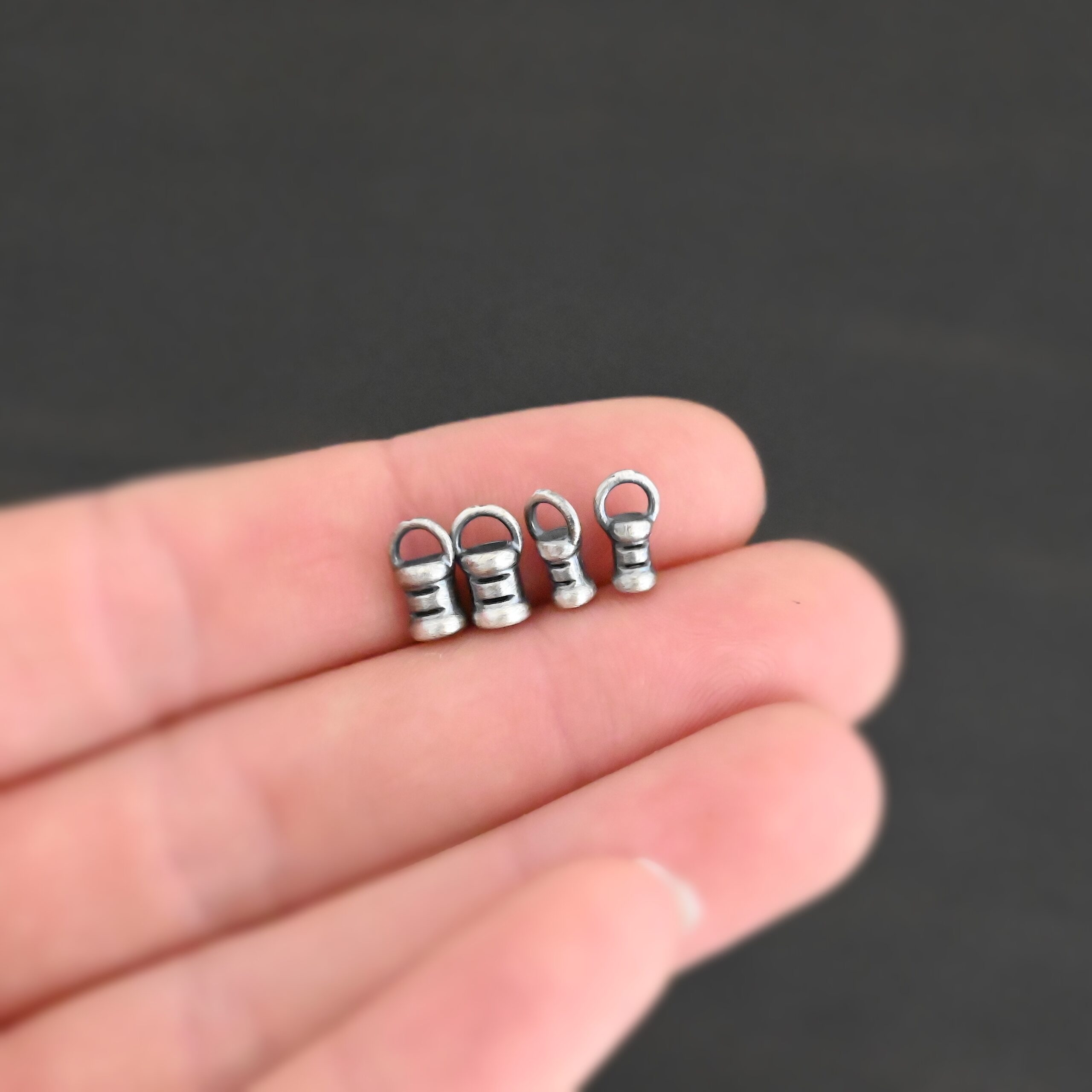 Silver oxidized 2mm & 3mm crimps shown in hand