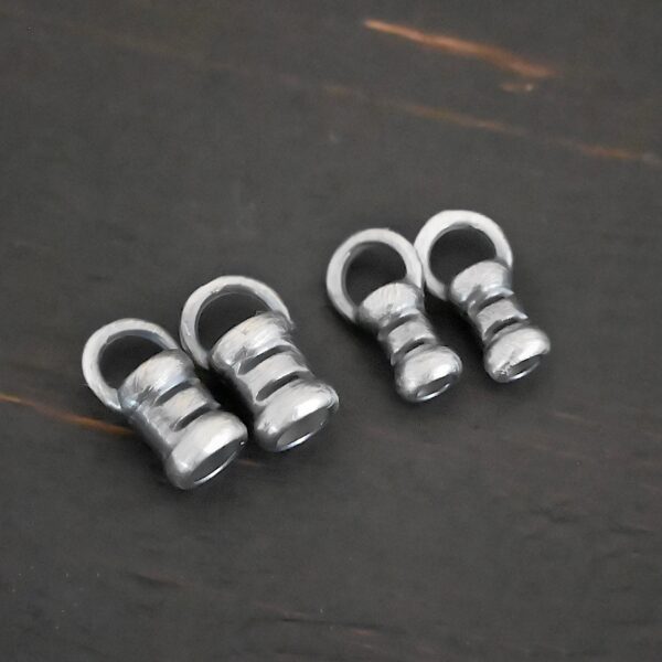 Silver oxidized 3mm & 2mm crimps shown on dark background