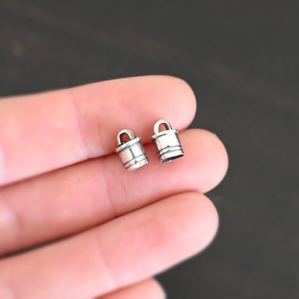 Silver Shiny 6x9mm end caps shown in hand
