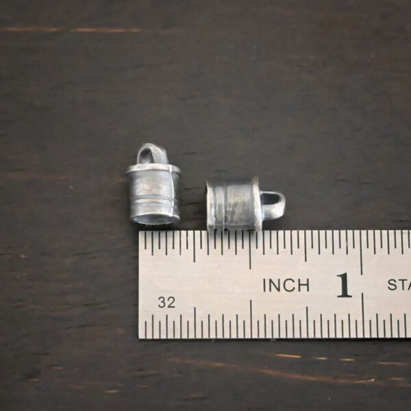 Silver oxidized 6x9mm end caps shown by ruler