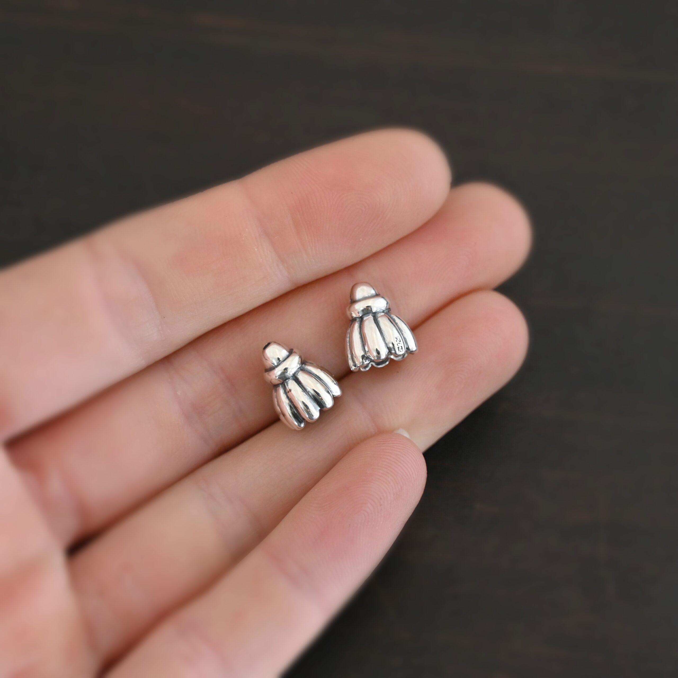 Silver Shiny Cone Flower Bead Caps shown in hand