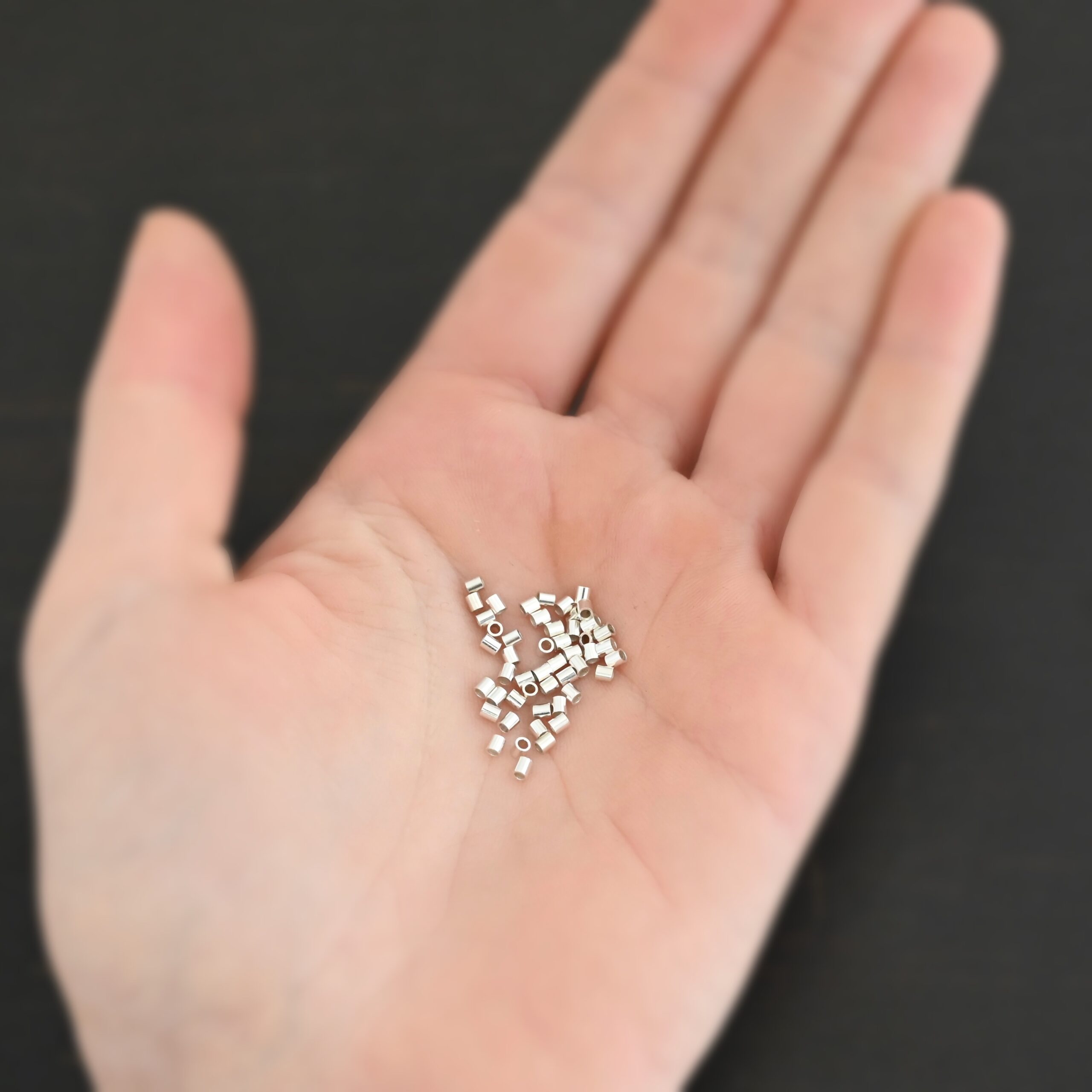 Silver shiny 2mm crimps shown in hand