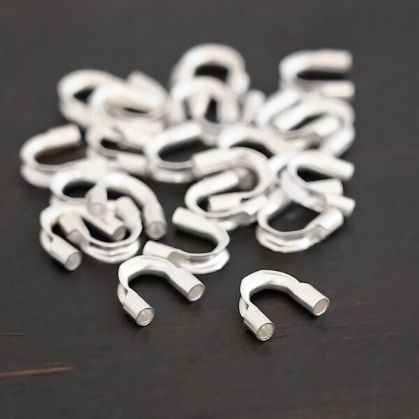 Silver shiny wire guards shown on dark background