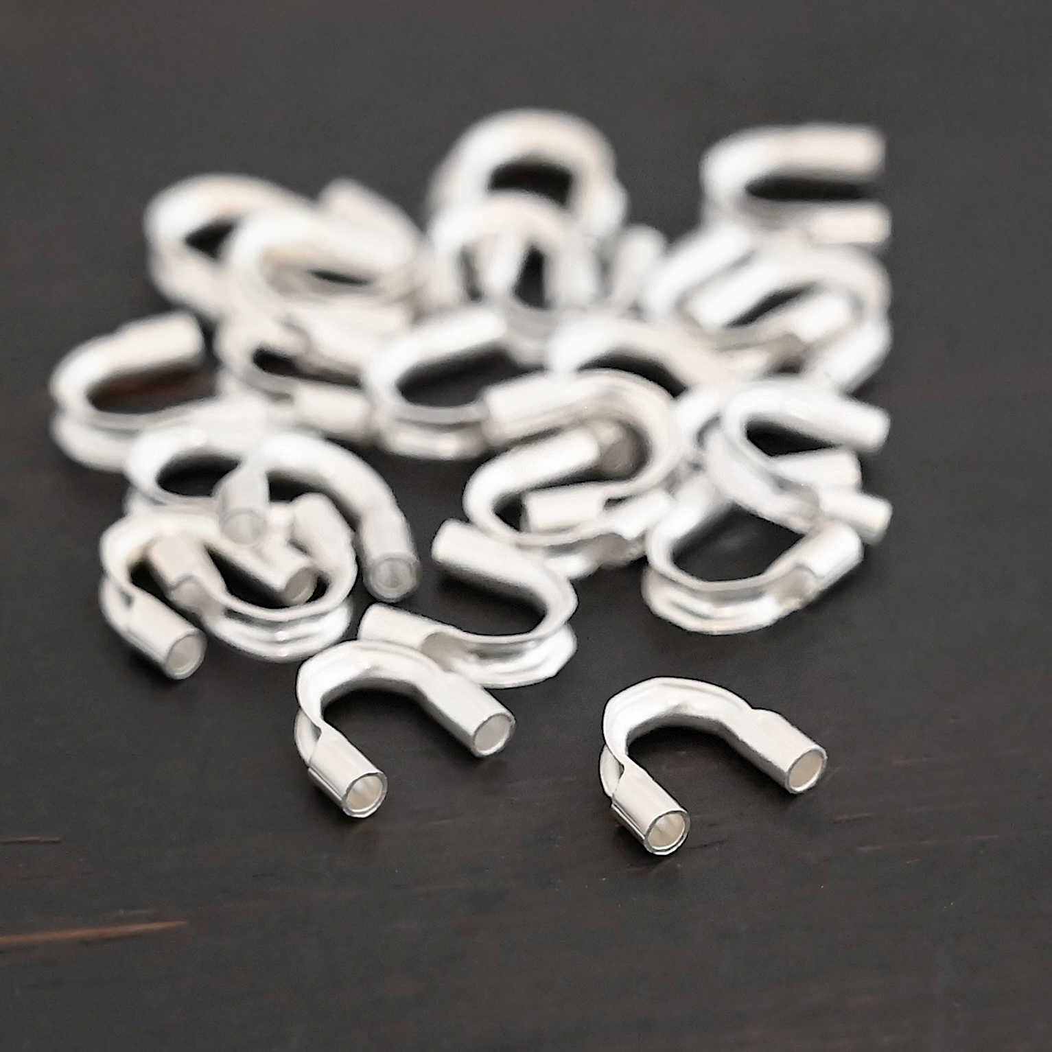 Wire Guards shiny Silver shiny wire guards shown on dark background