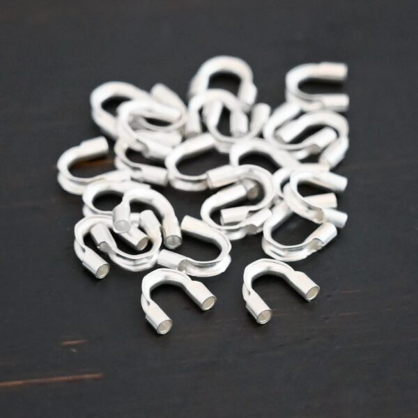 Silver shiny wire guards shown on dark background
