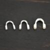Silver shiny wire guards shown on dark background