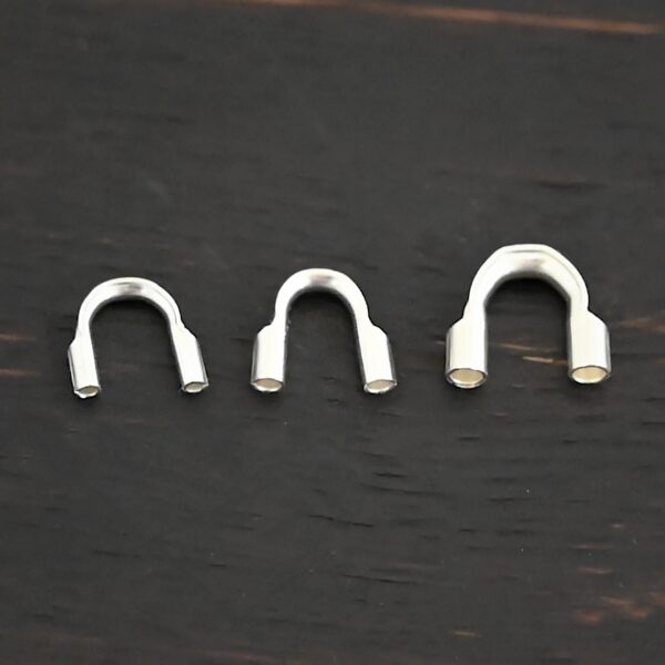 Silver shiny wire guards shown on dark background