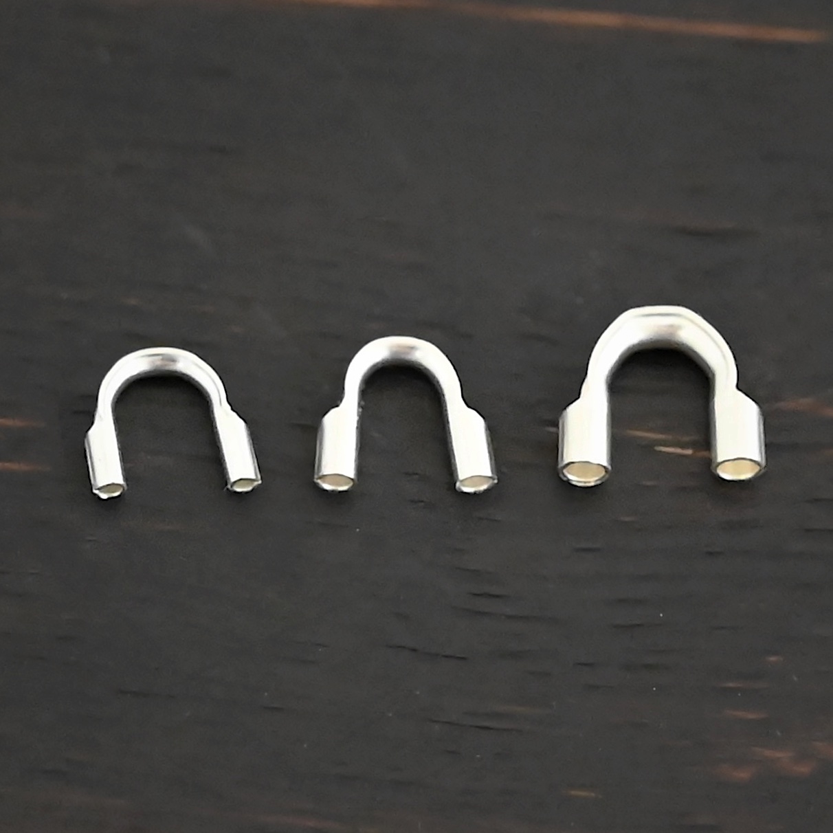 Wire Guards shiny Silver shiny wire guards shown on dark background