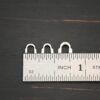 Silver shiny wire guards shown by ruler