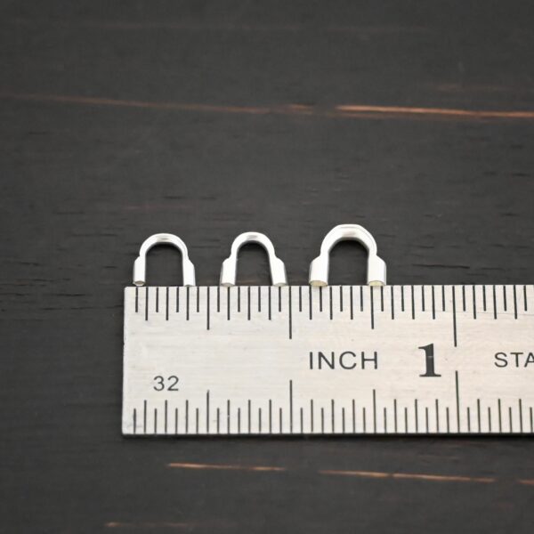 Silver shiny wire guards shown by ruler