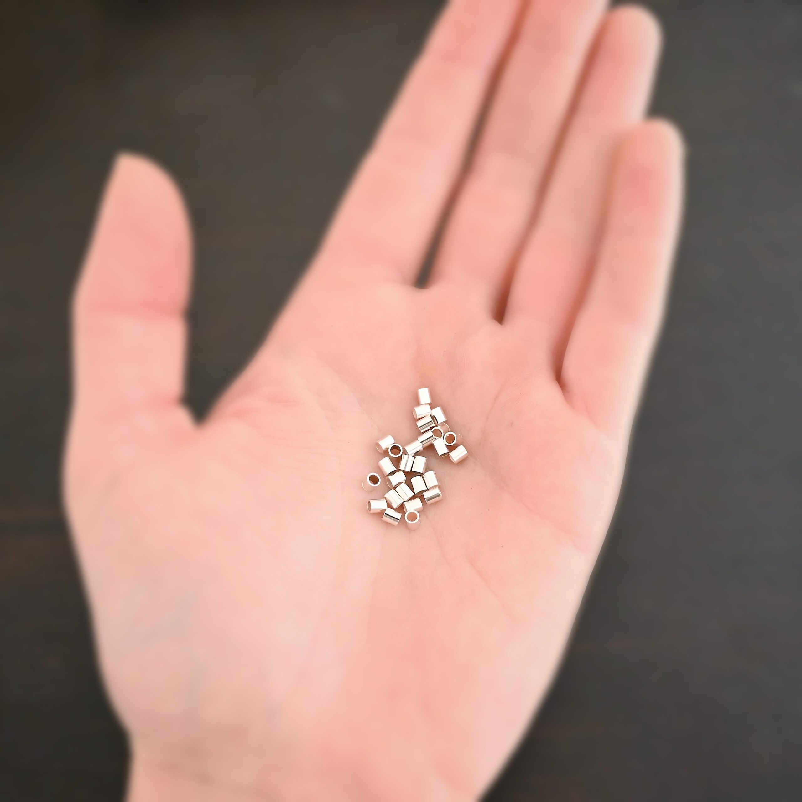 Silver shiny 3mm crimps shown in hand