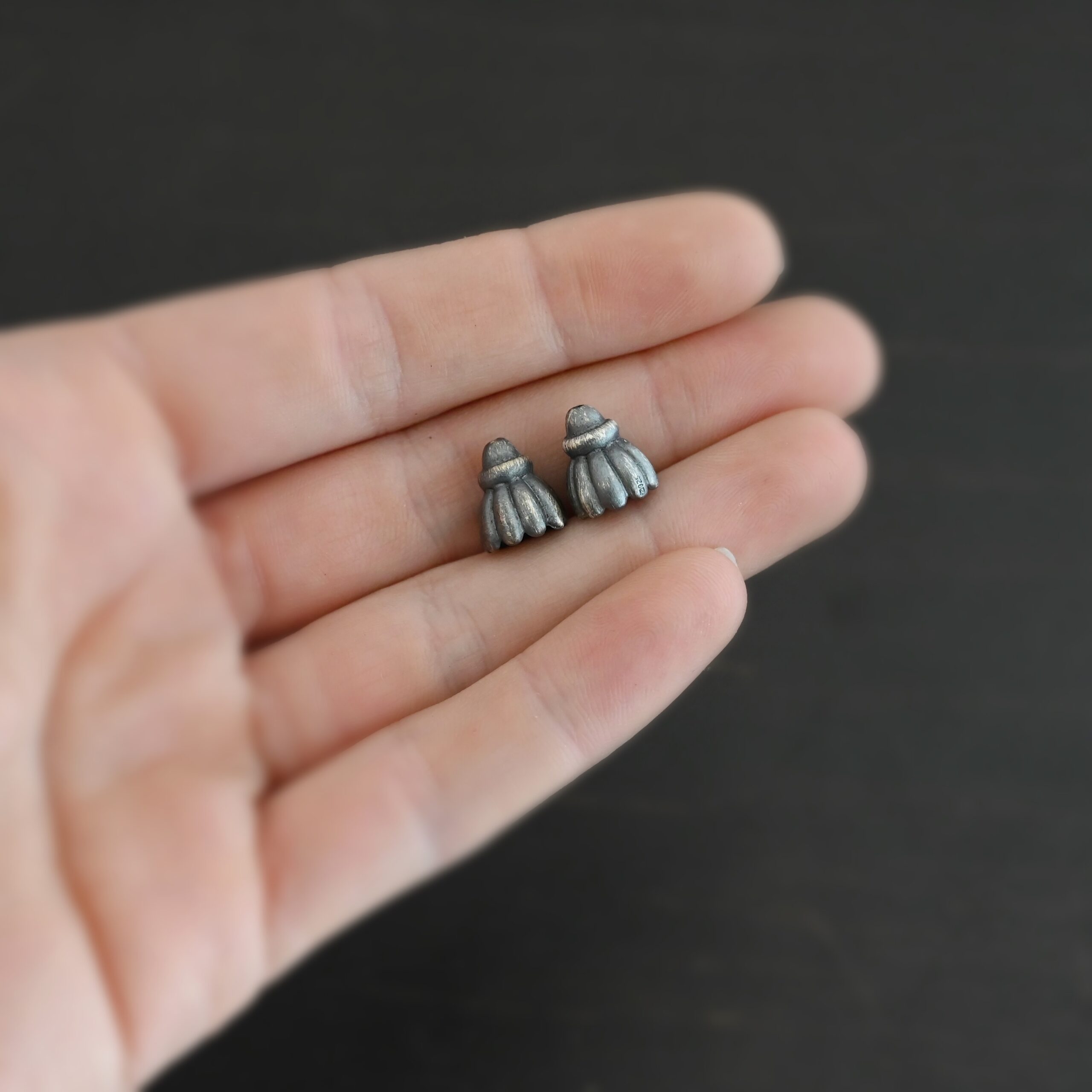 Silver oxidized cone flower bead cap shown in hand