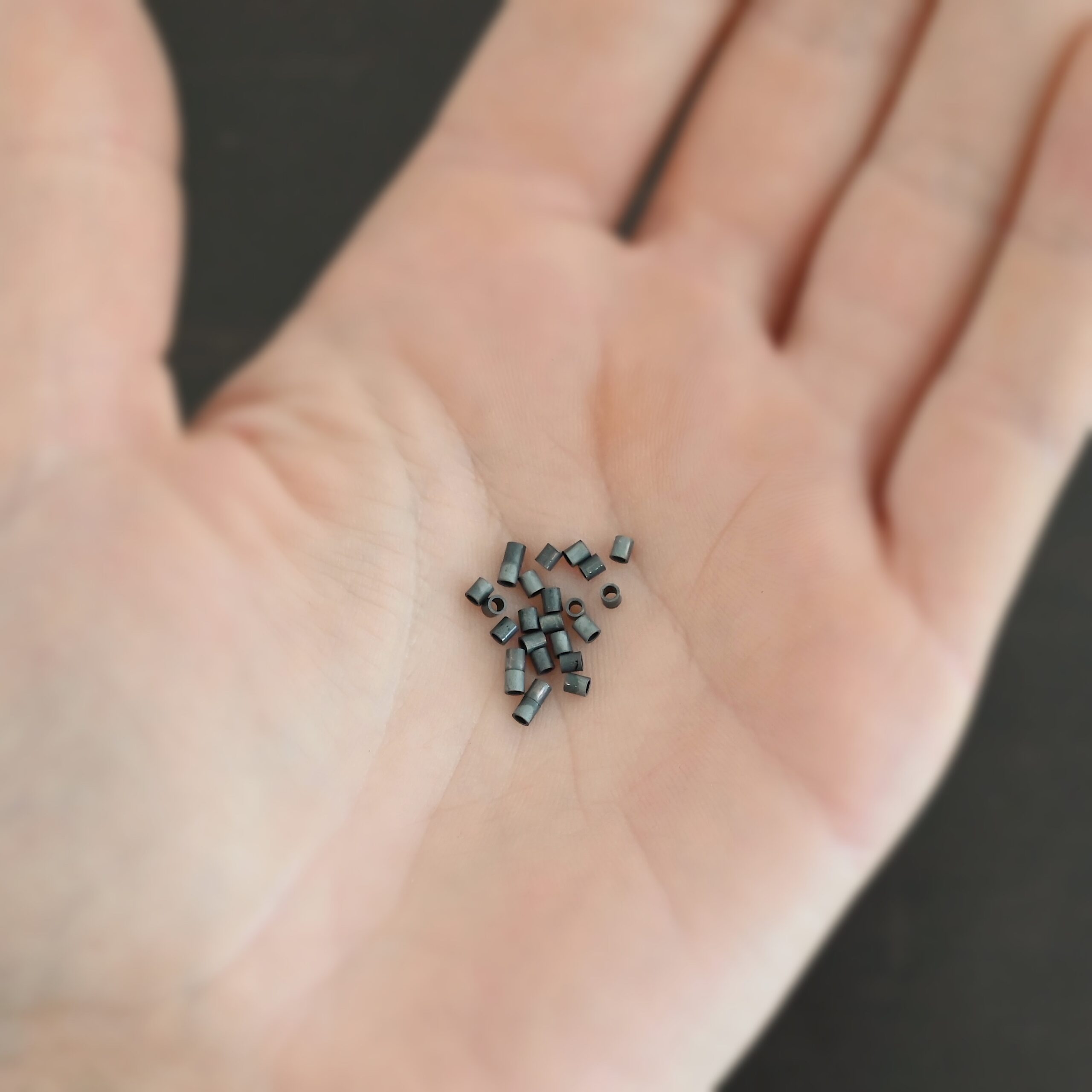 Silver oxidized 3mm crimps shown in hand
