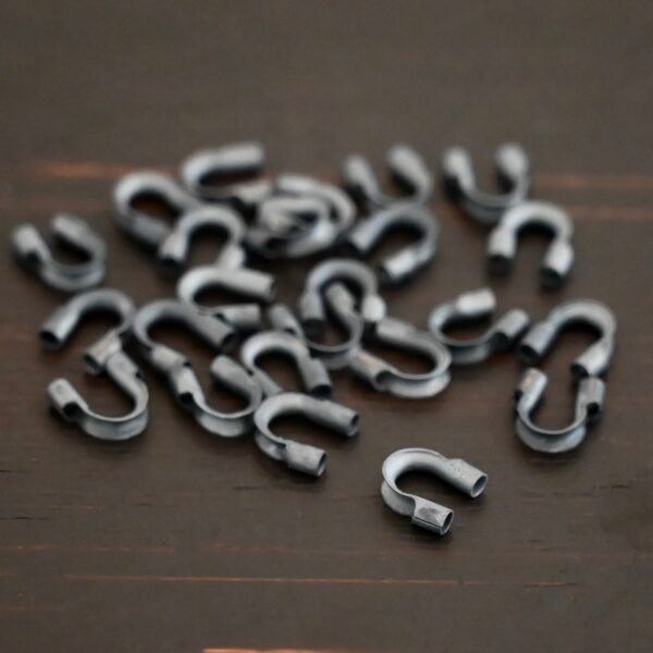Silver oxidized wire guards shown on dark background