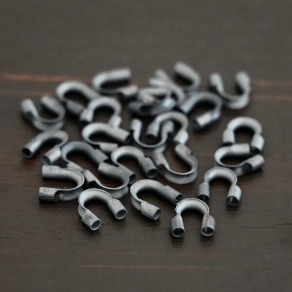 Silver oxidized wire guards shown on dark background
