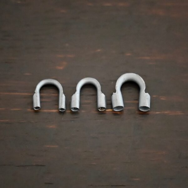 Silver oxidized wire guards shown on dark background