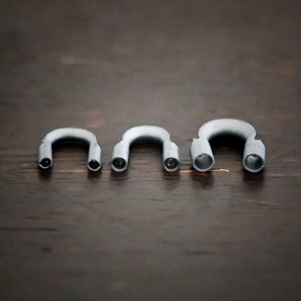 Silver oxidized wire guards shown on dark background