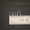 Silver oxidized wire guards shown by ruler