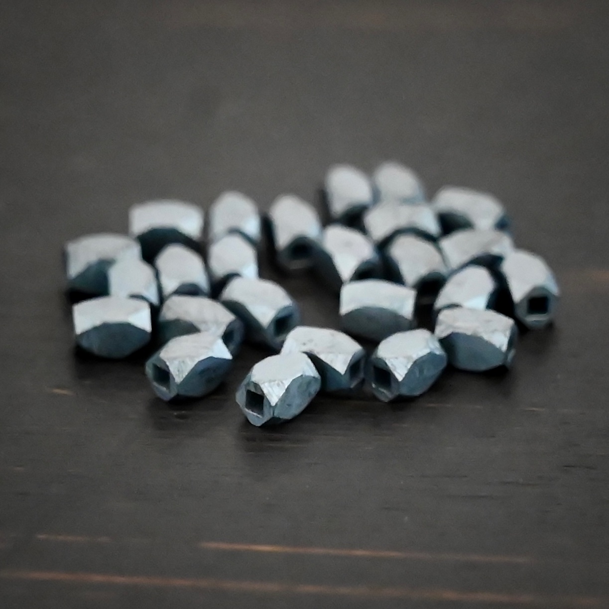 Silver oxidized rectangle beads shown on dark background