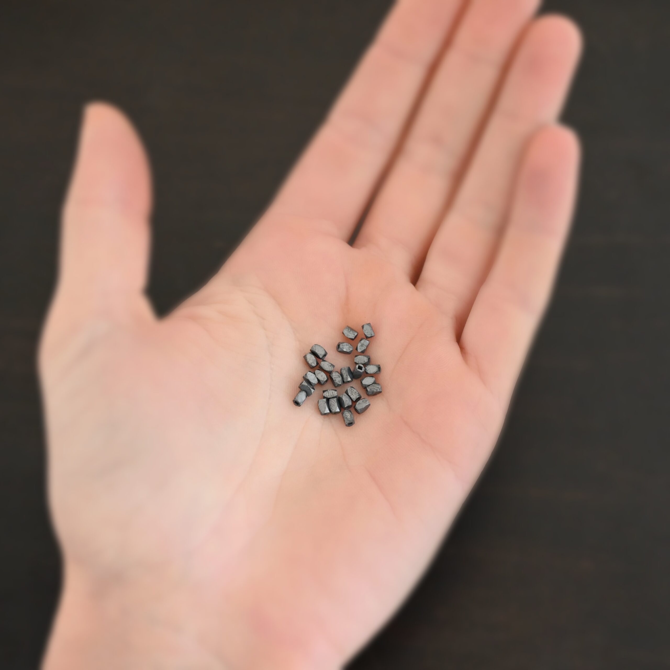 Silver oxidized rectangle beads shown in hand