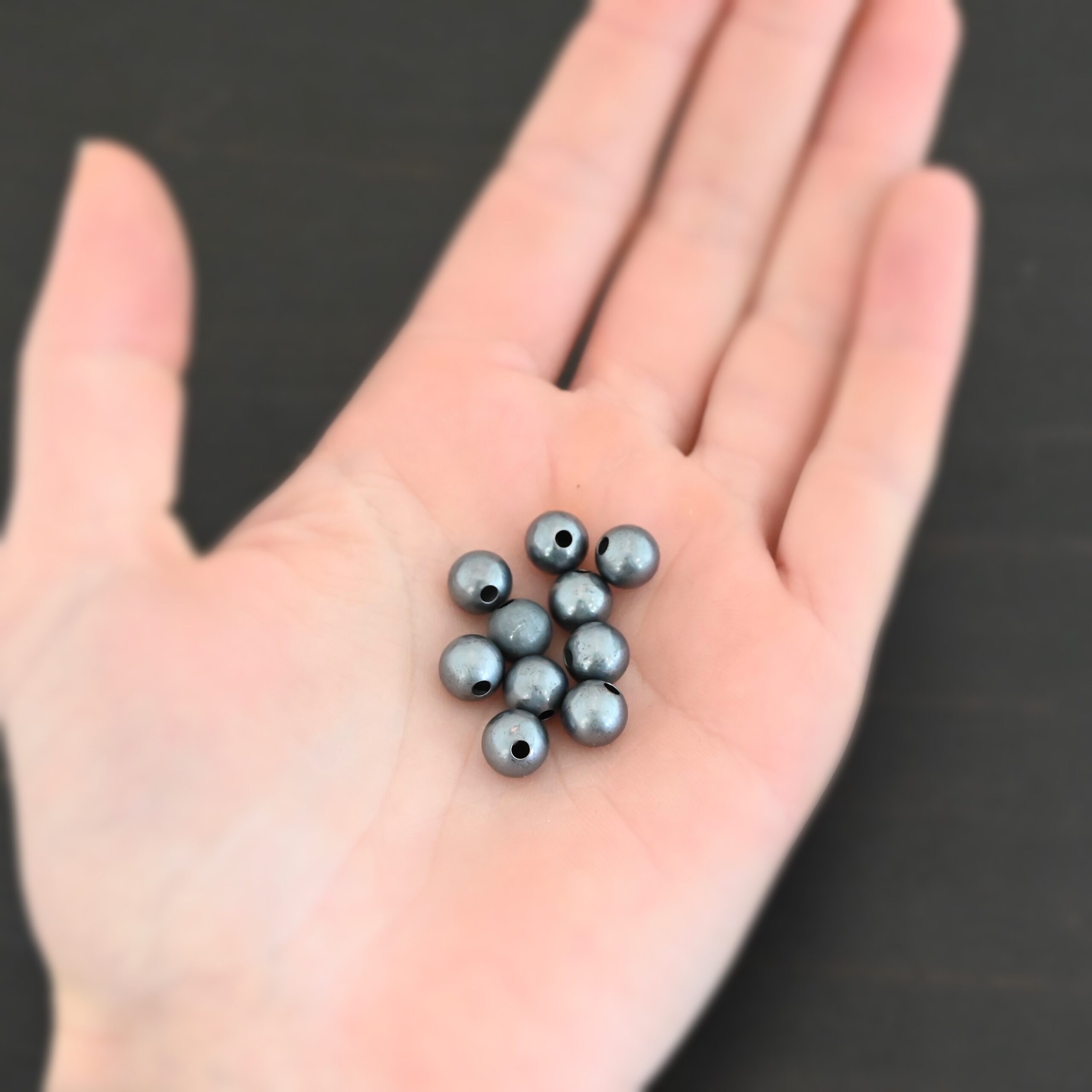 Silver oxidized hollow 8mm beads shown in hand 10pcs