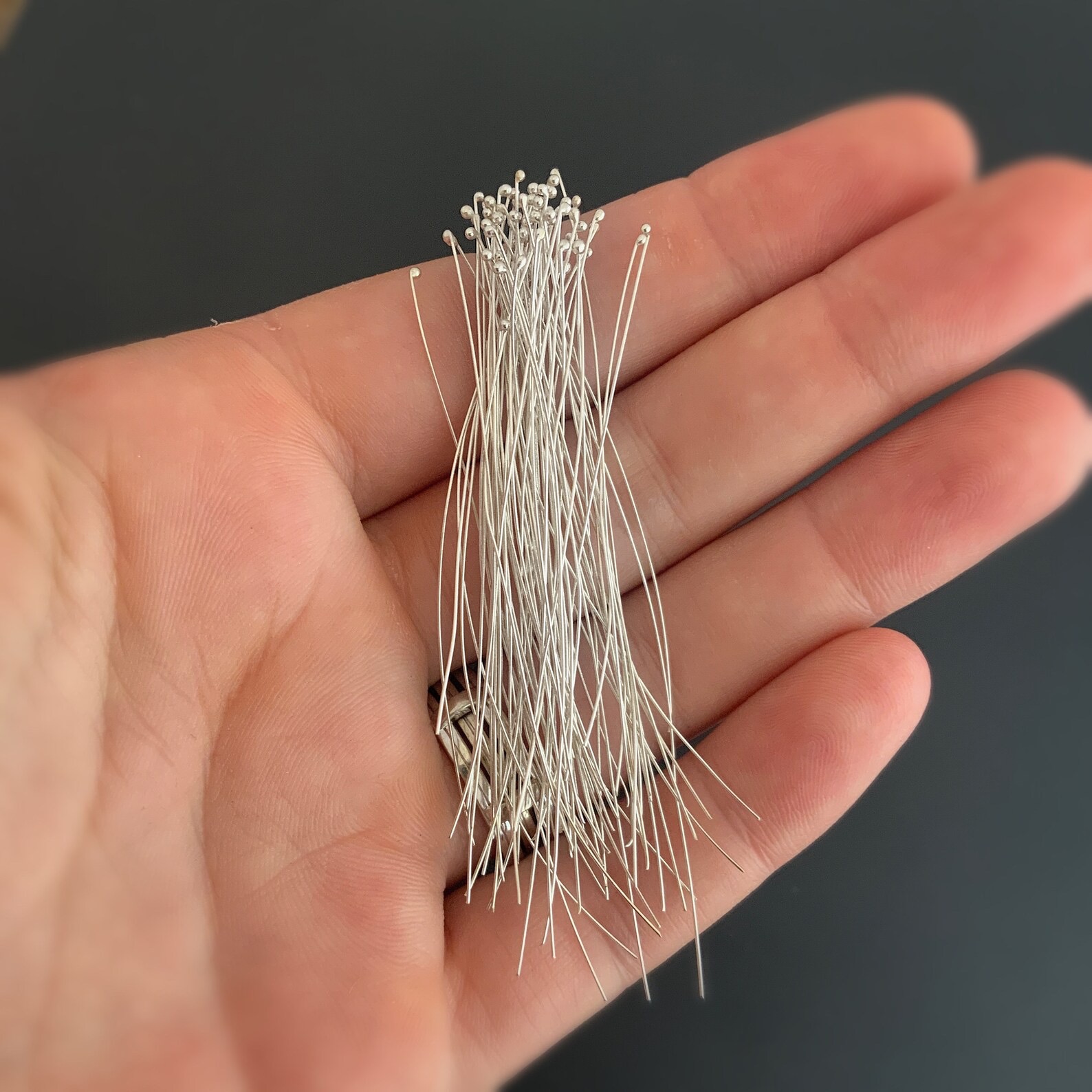 Smaller Ball Headpins Small Shiny Silver Ball Headpins shown in hand