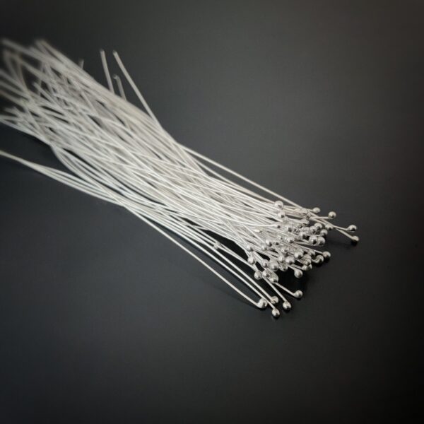 Small Shiny Silver Ball Headpins shown on dark background