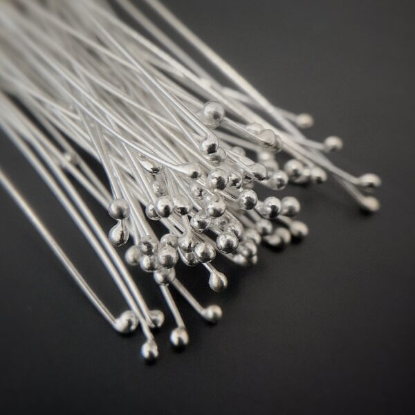 Small Shiny Silver Ball Headpins shown on dark background