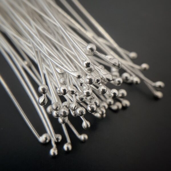 Small Shiny Silver Ball Headpins shown on dark background