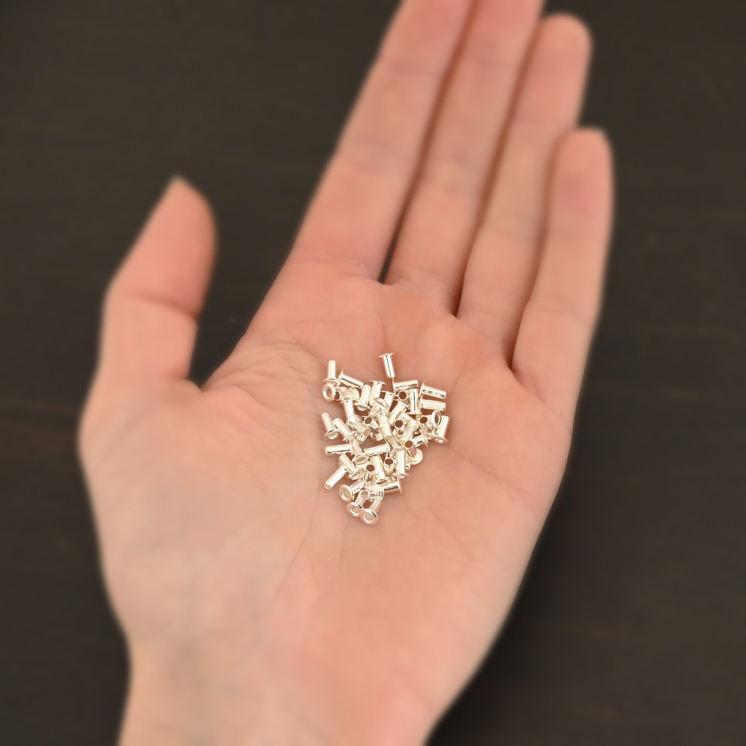 3/32x1/5 Silver plated eyelets shown in hand