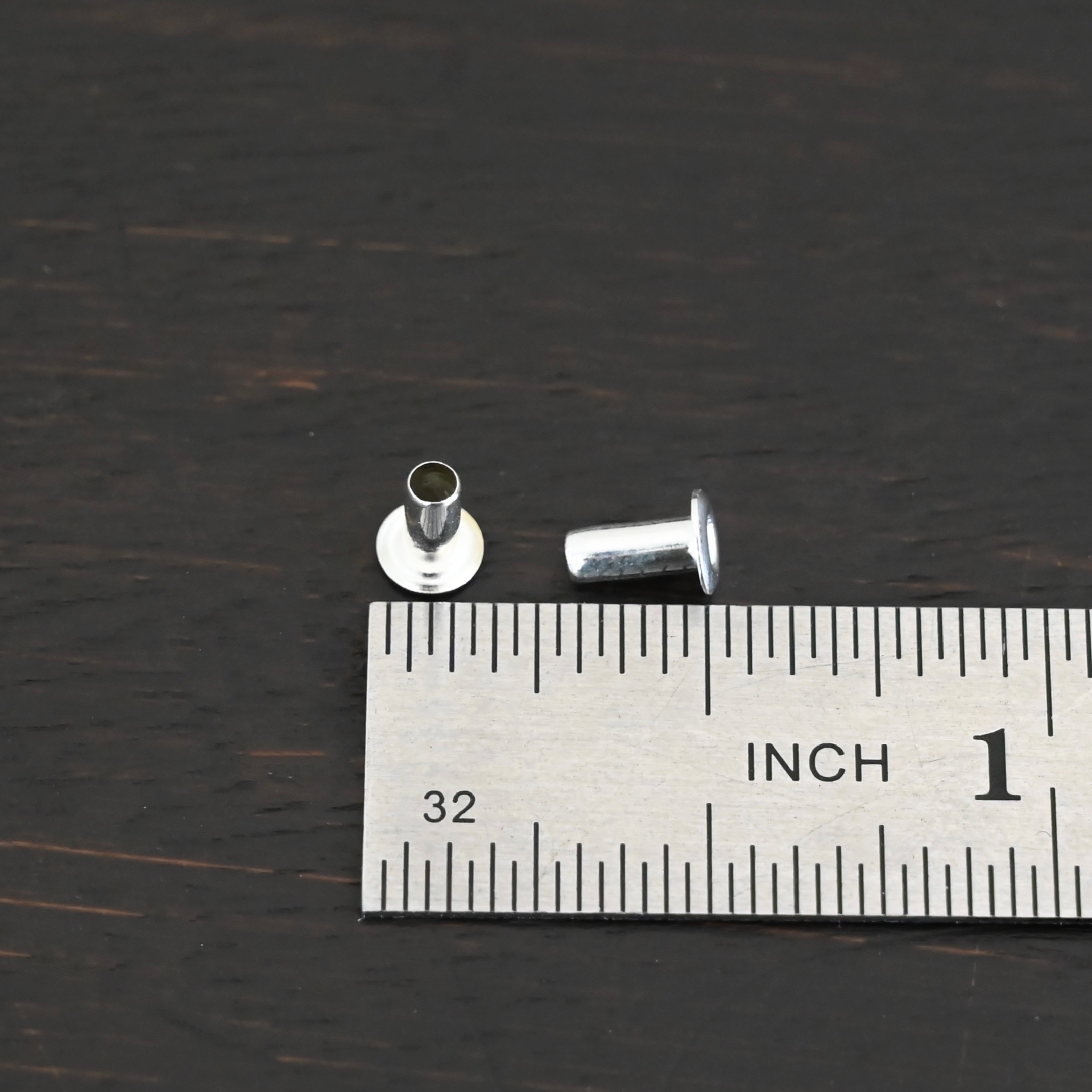 3/32x1/5 Silver plated eyelets shown by ruler