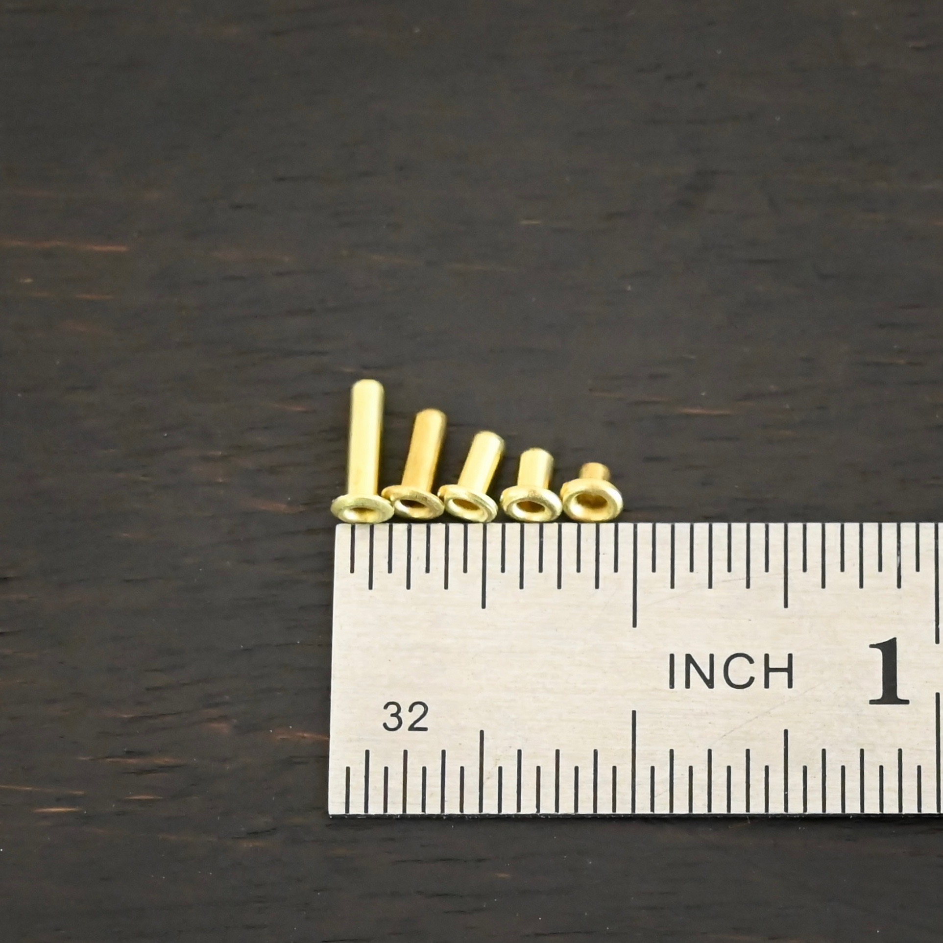 Brass eyelets mix of all shown by ruler