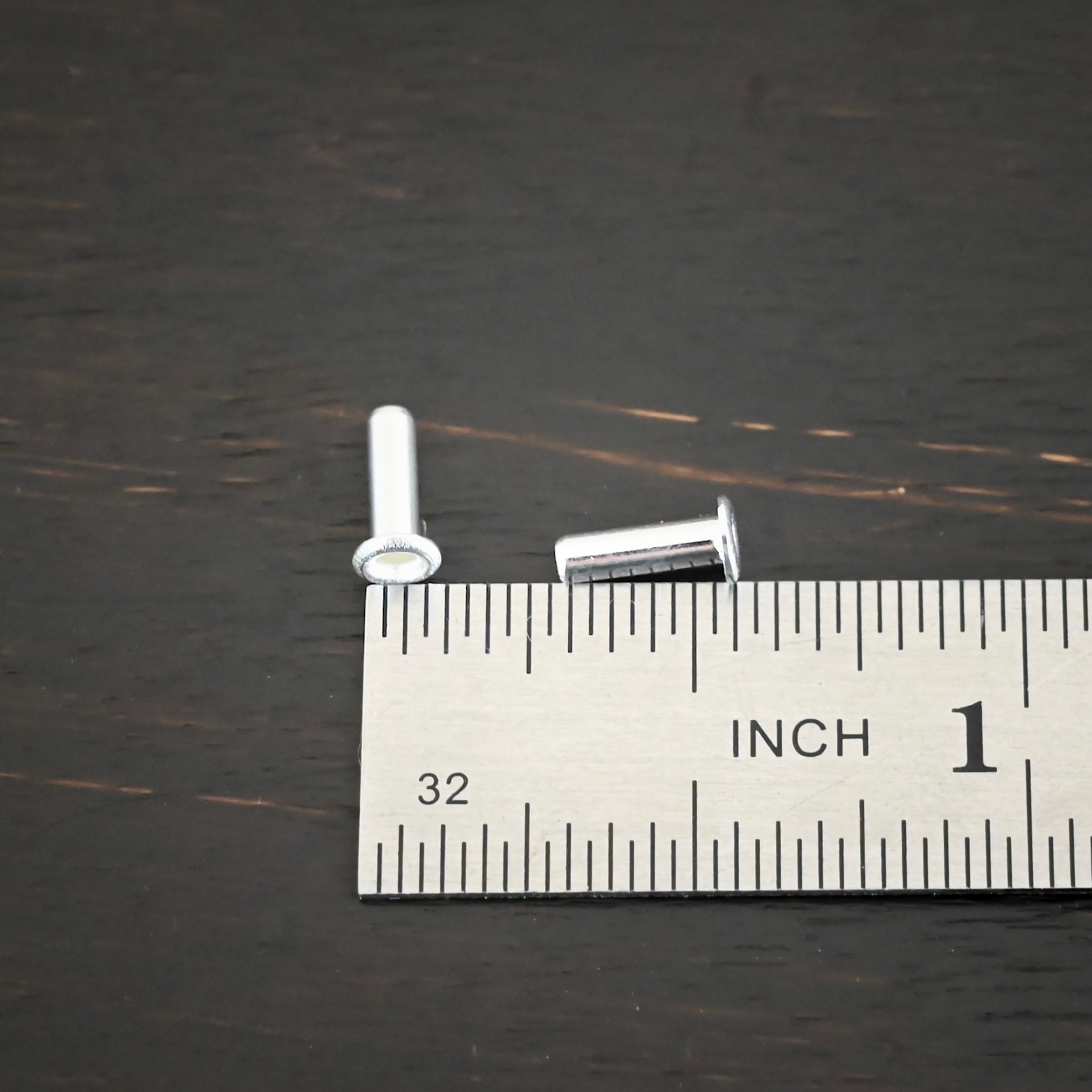 3/32x1/4 plated silver eyelets shown by ruler