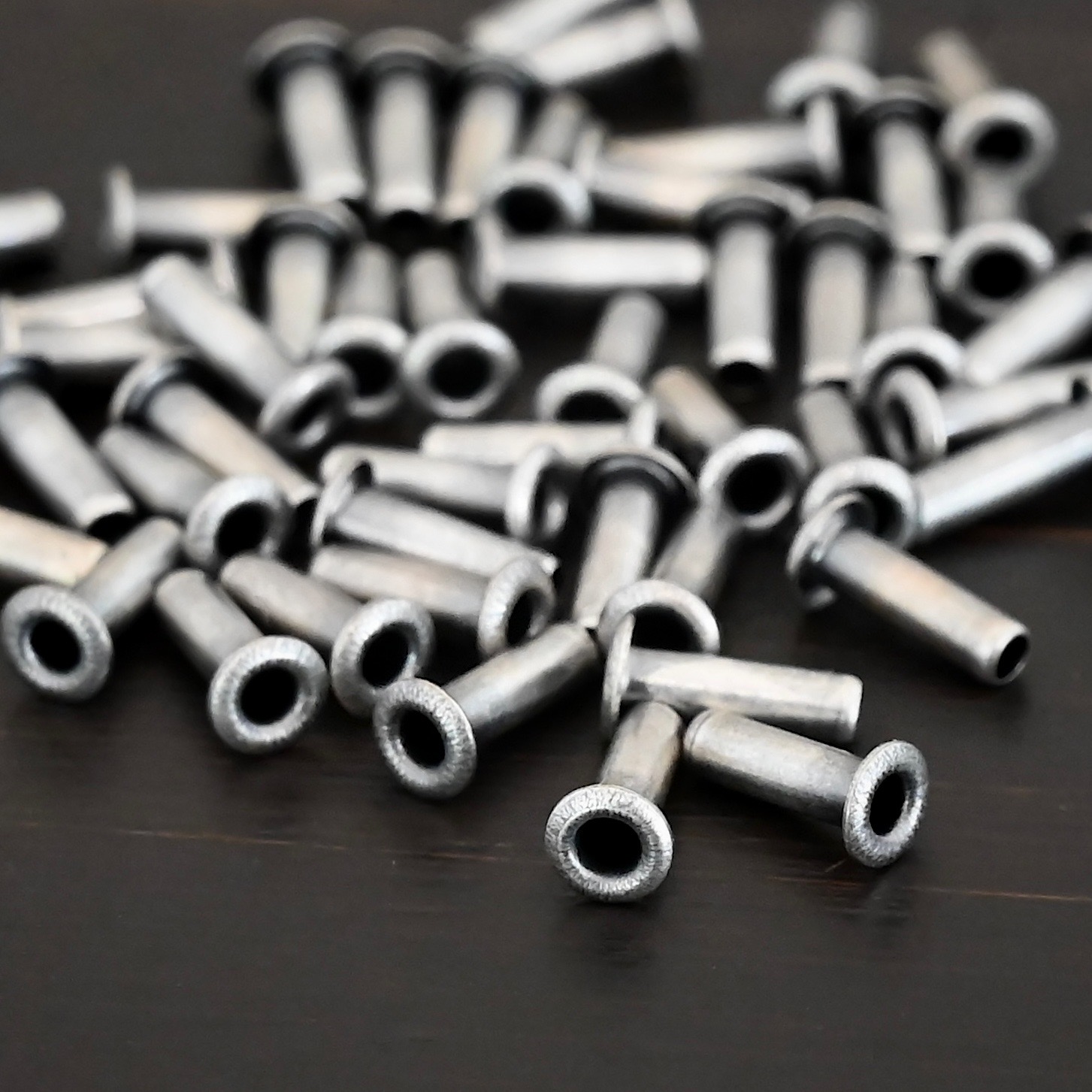 3/32x1/4 plated antique silver eyelets shown on dark background