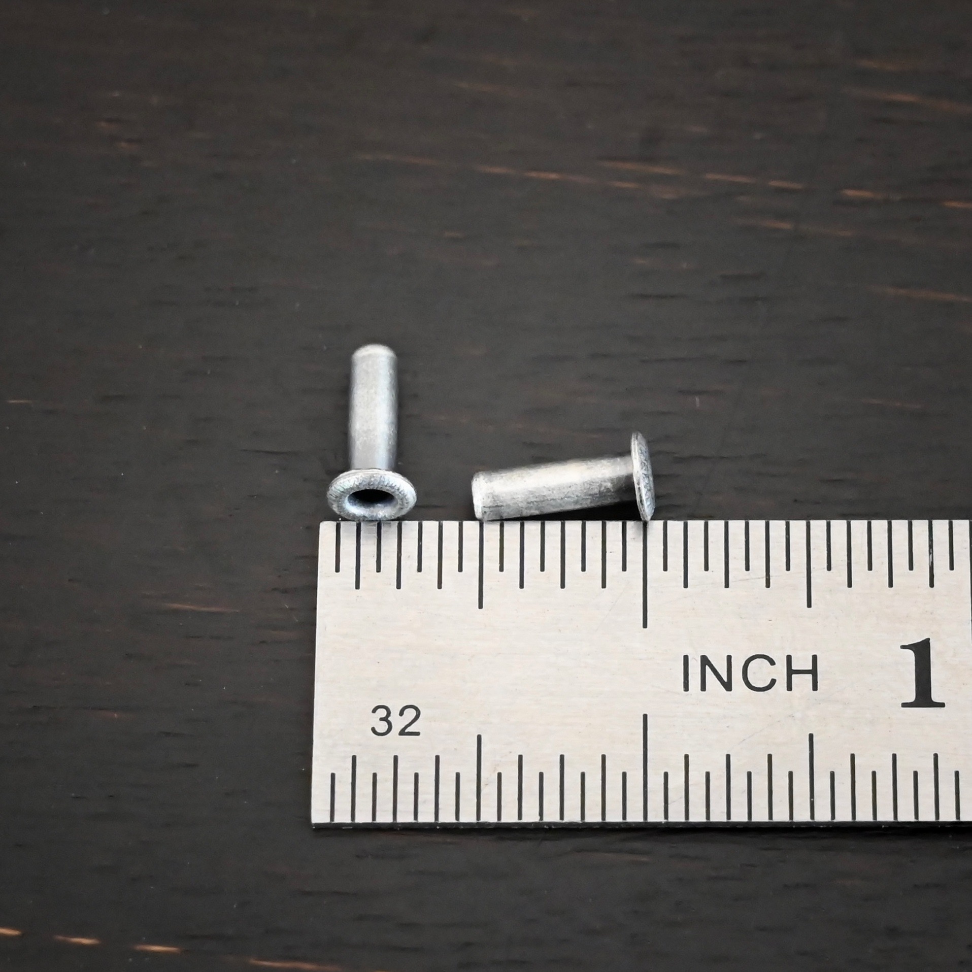 3/32x1/4 plated antique silver eyelets shown by ruler