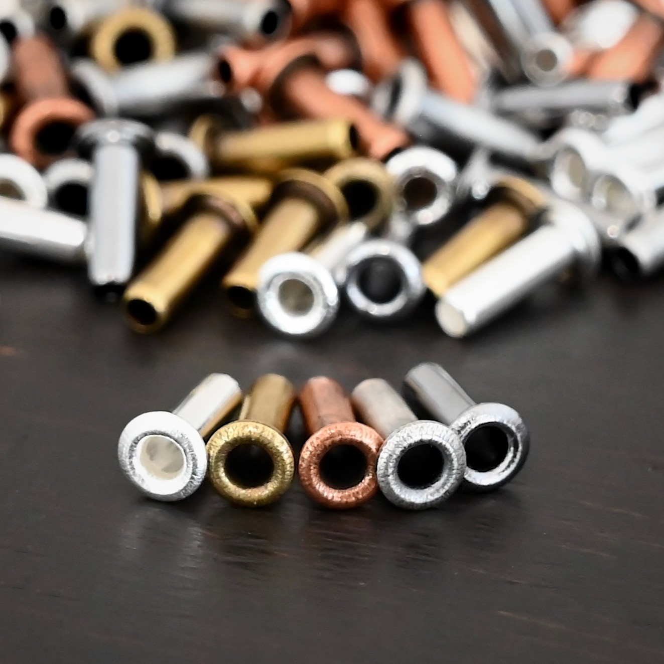 3/32x1/4 Plated Eyelets eyelets shown on dark background