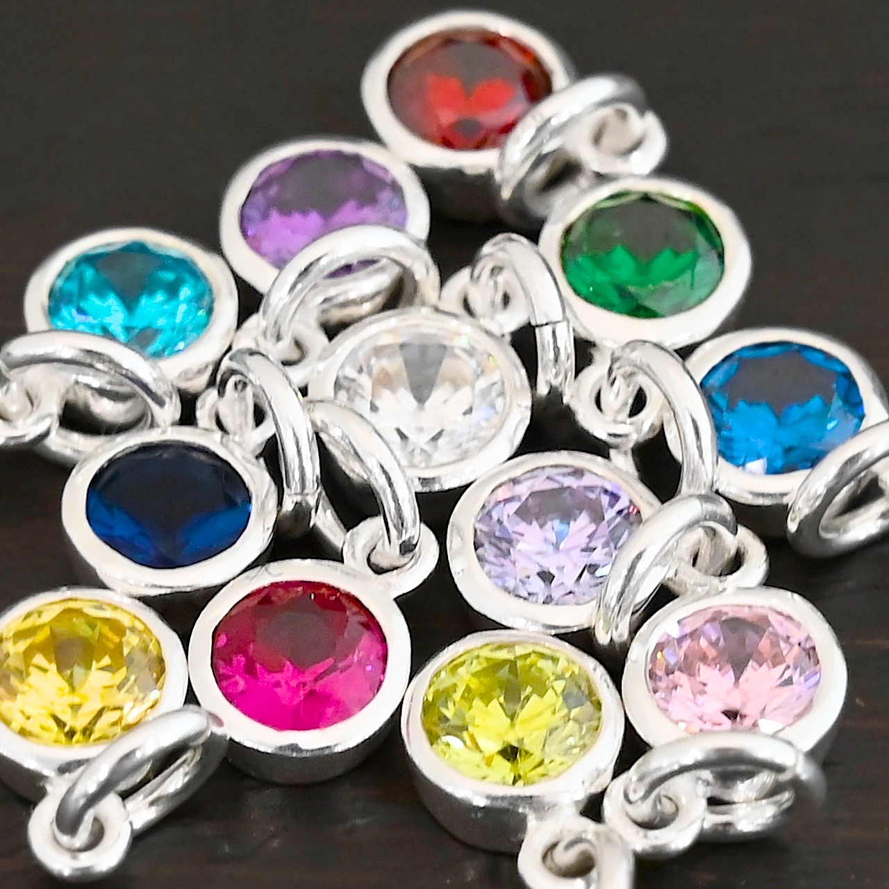 Silver 6mm Birthstone Silver Shiny 6mm Birthstone Charms shown on dark background