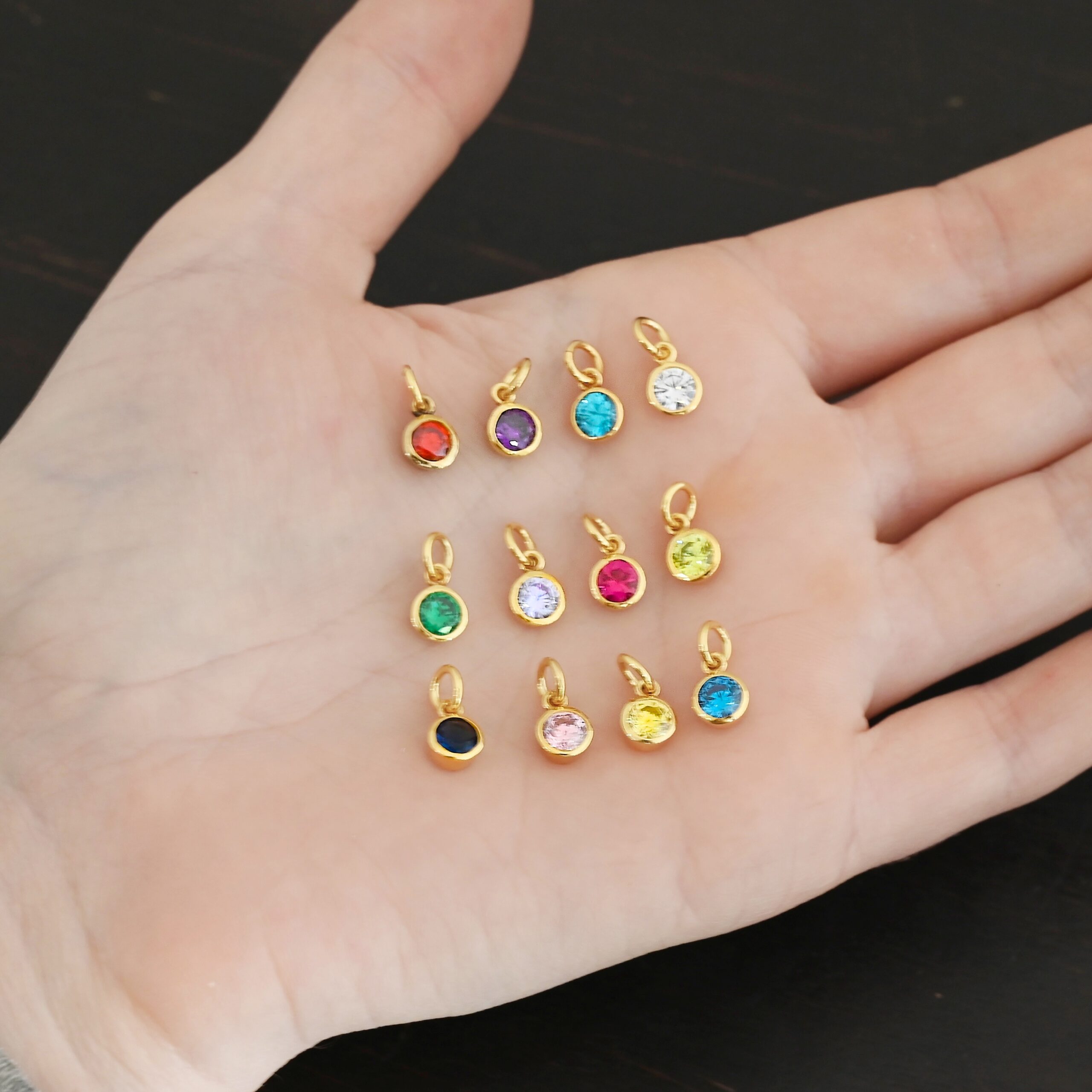 Gold Plated 6mm Birthstone Charms shown in hand
