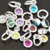 Silver shiny 4mm Birthstone Charms shown on dark background