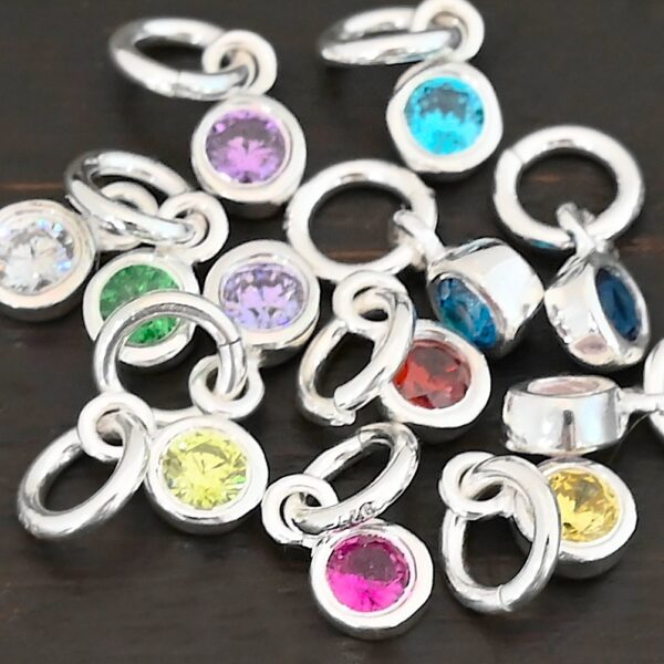 Silver shiny 4mm Birthstone Charms shown on dark background