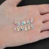 Silver shiny 4mm Birthstone Charms shown in hand