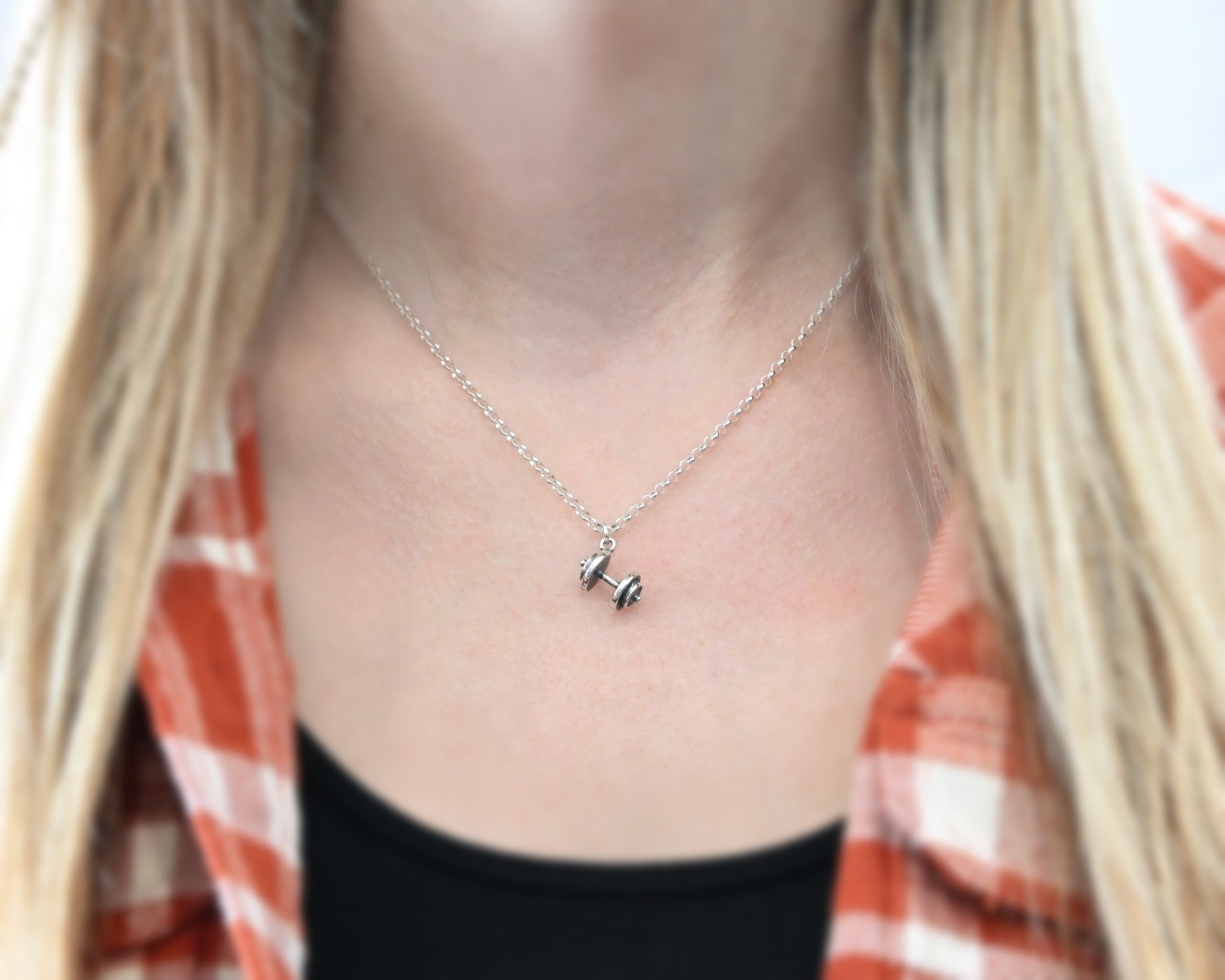 Silver barbell charm necklace shown on model