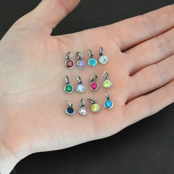Silver oxidized 6mm Birthstone Charm shown in hand