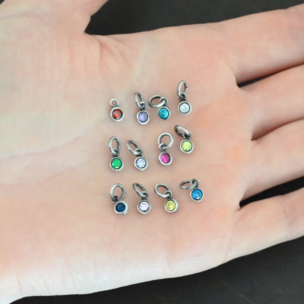Silver oxidized 4mm Birthstone Charms shown in hand