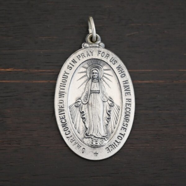 Silver Mary Medallion Oval Charm 20x29mm on dark background