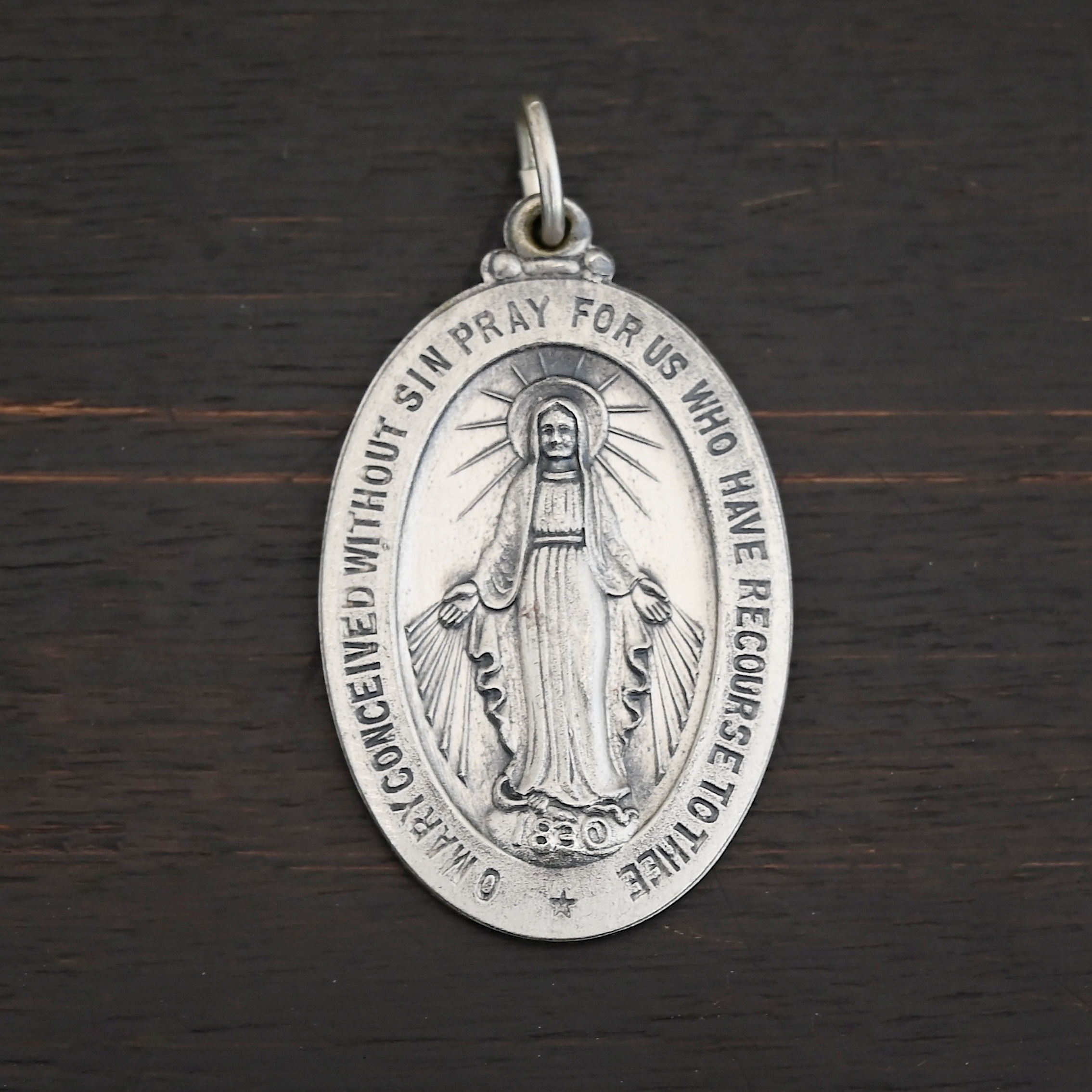 Mary Medallion Charm - 20x29mm Silver Mary Medallion Oval Charm 20x29mm on dark background