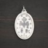 Back side of Silver Mary Medallion Oval Charm 20x29mm on dark background
