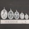 Silver Mary Medallion Oval Charms all sizes shown by ruler